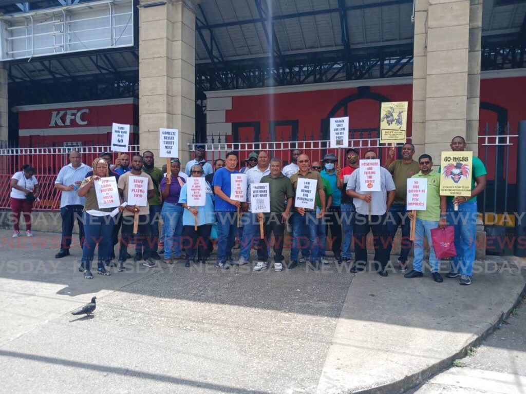 Members of the Transport and Industrial Workers' Union protesting outside of City Gate in Port of Spain on Tuesday. - Photo by Joey Bartlett