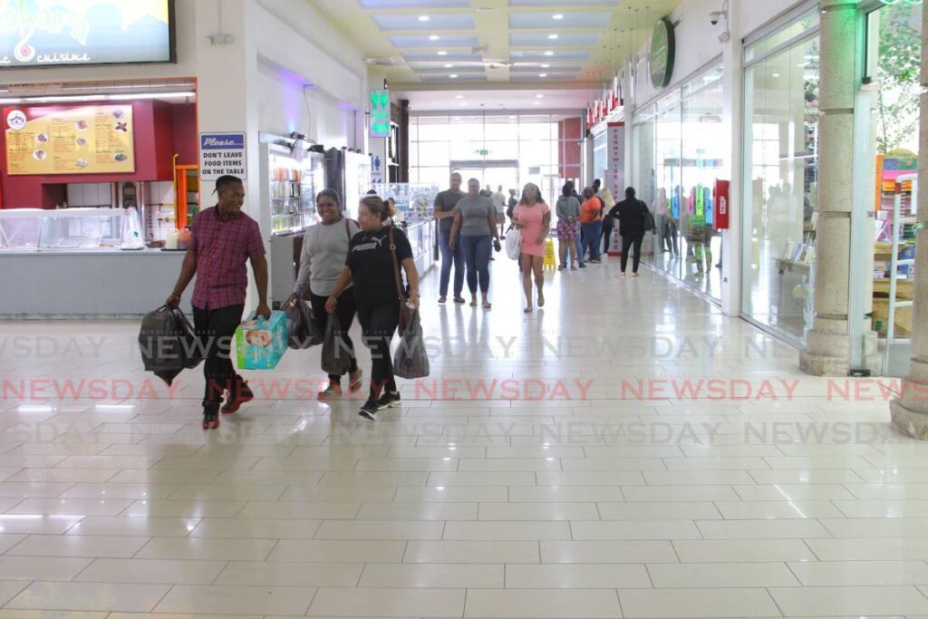 Shoppers at Trincity Mall which is up for sale. File photo - 