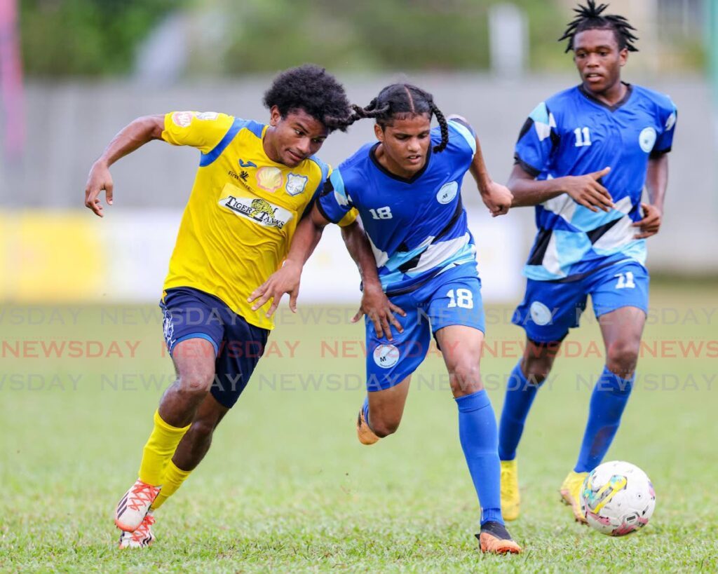 In this file photo, Malick’s Keston Singh (C) wins the duel for possession against Speyside’s Omar Daniel (L) during the Secondary School Football League premiership match at the St Mary’s College grounds on September 23, in Port of Spain.  - DANIEL PRENTICE