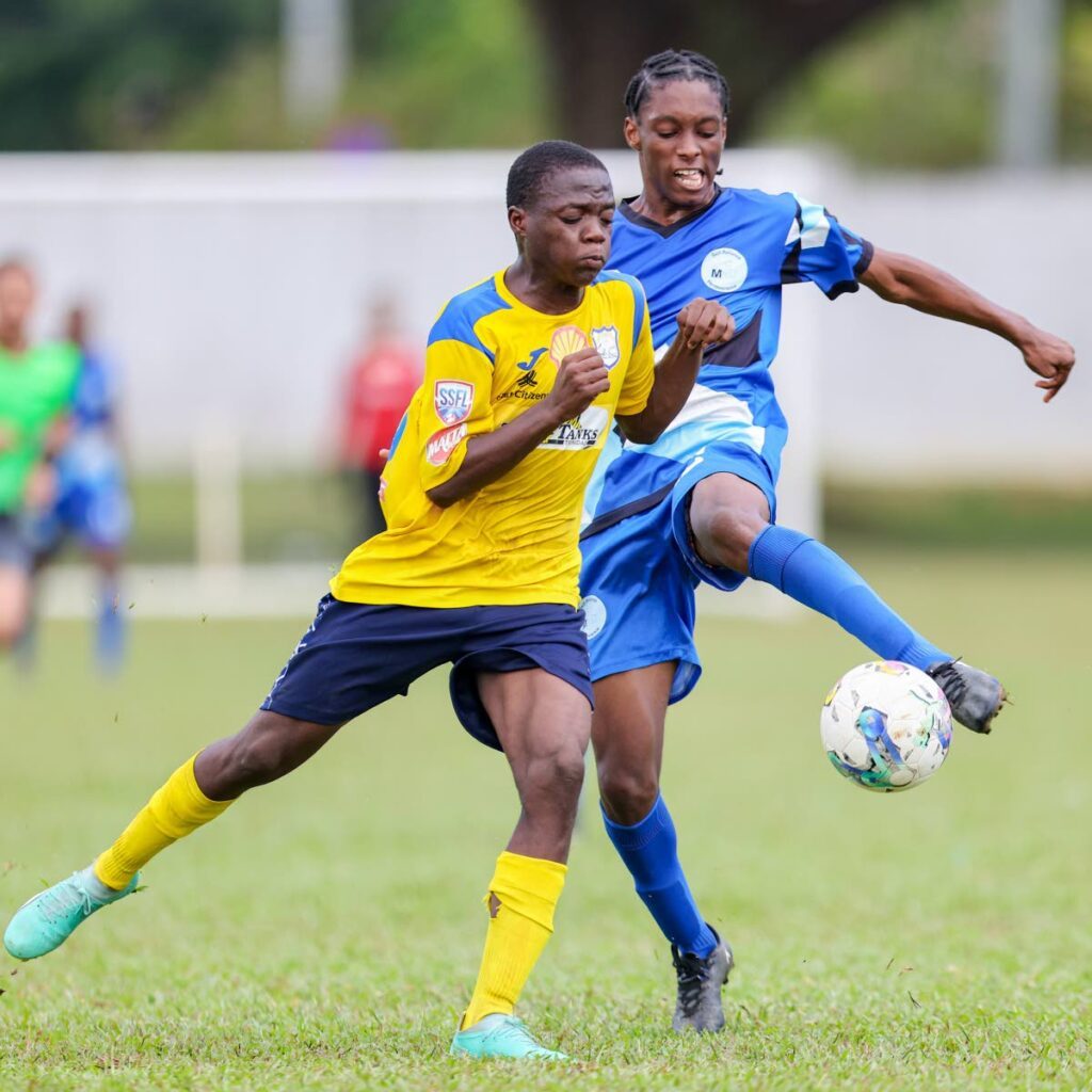 In this photo taken on September 23, Malick’s Daquan Thomas, right, clears the ball away from Speyside’s Shyon George during the Secondary School Football League premiership match at the St Mary’s College grounds, in Port of Spain. Speyside beat Bishop’s High School 1-0, on Wednesday, to claim the Tobago Intercol Boys’ title.  - DANIEL PRENTICE