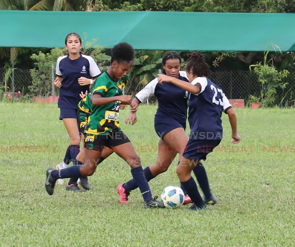 Diego Martin Central's Naima Julius, centre, is closed down quickly against St Joseph's Convent Port of Spain during a Secondary Schools Football League premier division game earlier this season.  - Photo by ROGER JACOB