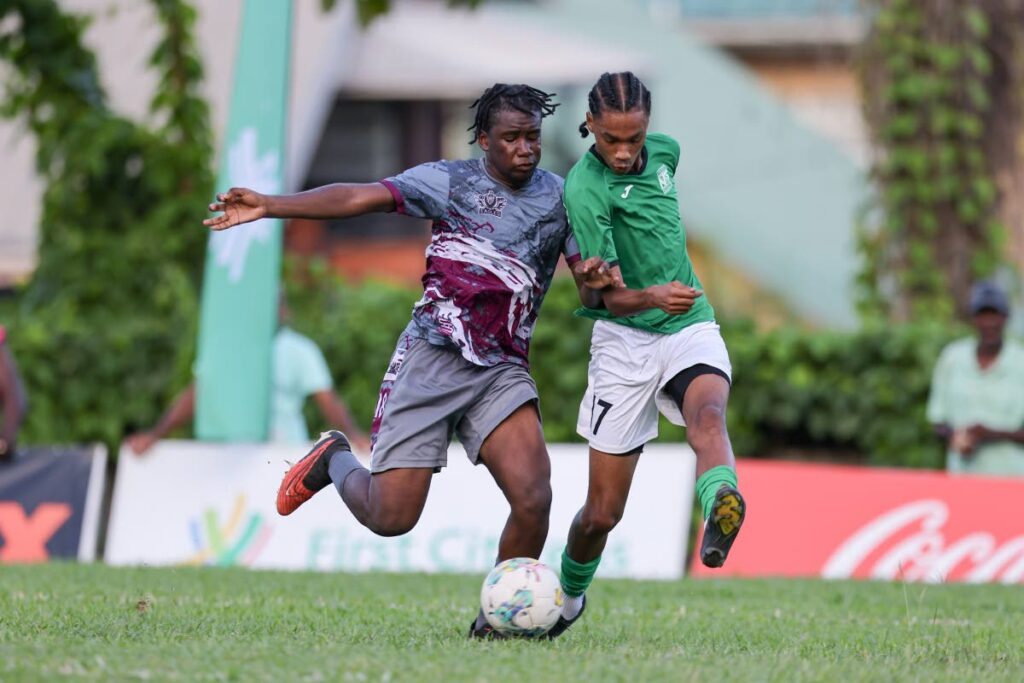 In this file photo, San Juan North Secondary Jahdel Chase-Charles (R) and Bishop’s High’s Adriano Murray vie for possession during the Secondary School Football League Premiership match at the San Juan North Secondary, in San Juan. - Daniel Prentice