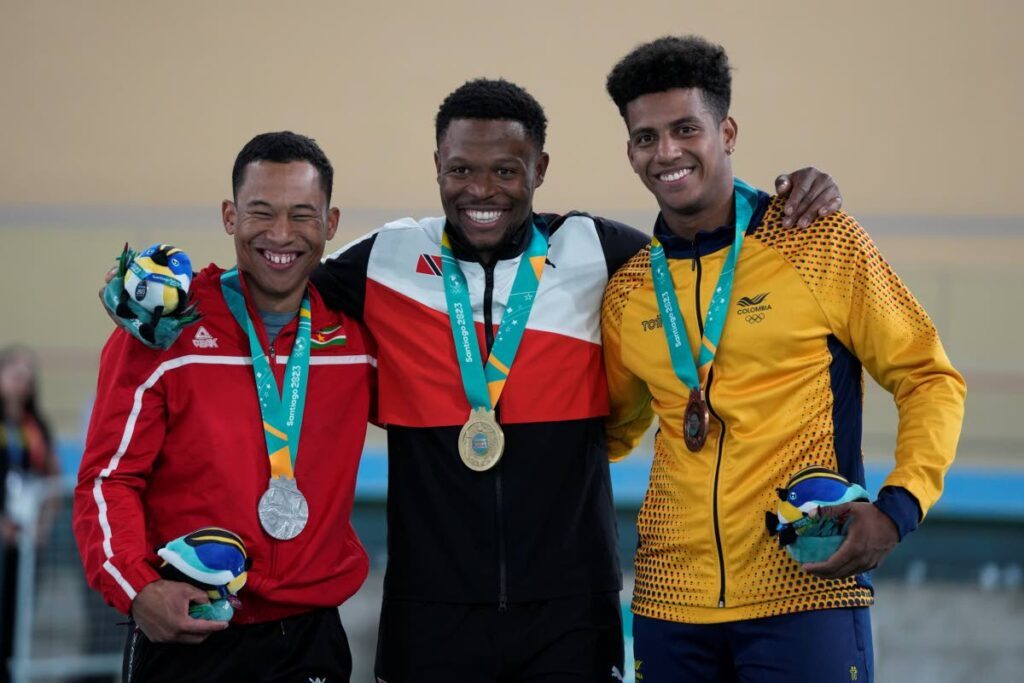 Medallists, from left, Surinam's Jair Tjon, silver, Trinidad and Tobago's Nicholas Paul, gold, and Colombia's Kevin Quintero, bronze pose with their cycling track men's sprint medals at the Pan American Games in Santiago, Chile, on October 26. - AP PHOTO