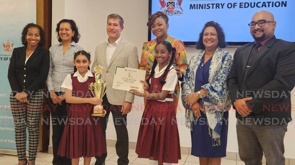 Junior first place winners Rio Claro Hindu SDMS at the IEAT school garden competition held at Nutrien Trinidad Ltd, Perseverance, pose for a photo with Josanne Basanoo co-ordinator model farm operation, Lieselle Harripersad, snr manager productions at Nutrien Erik Vettergrenm MD of Nutrien Trinidad, Minister of Education Nyan Gadsby-Dolly, director curriculum planning and development Anna Singh and curriculum officer Vishal Ramjattan. - Yvonne Webb 