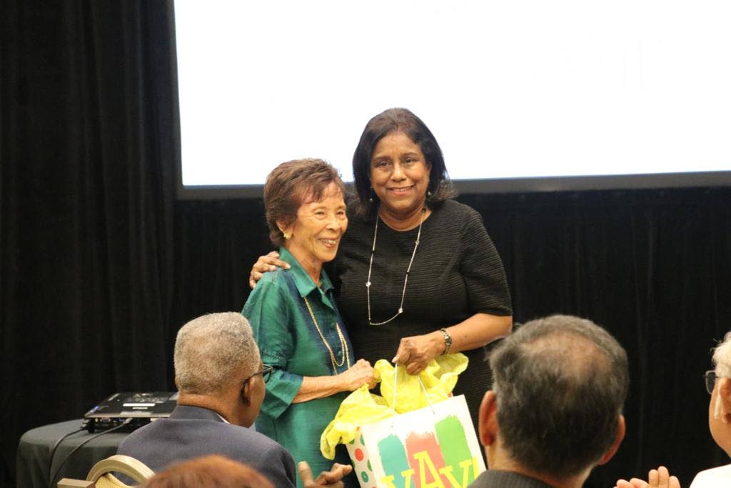 Joyce Welch, 97, gets a hug from Minister of Trade and Industry Paula Gopee-Scoon. - 