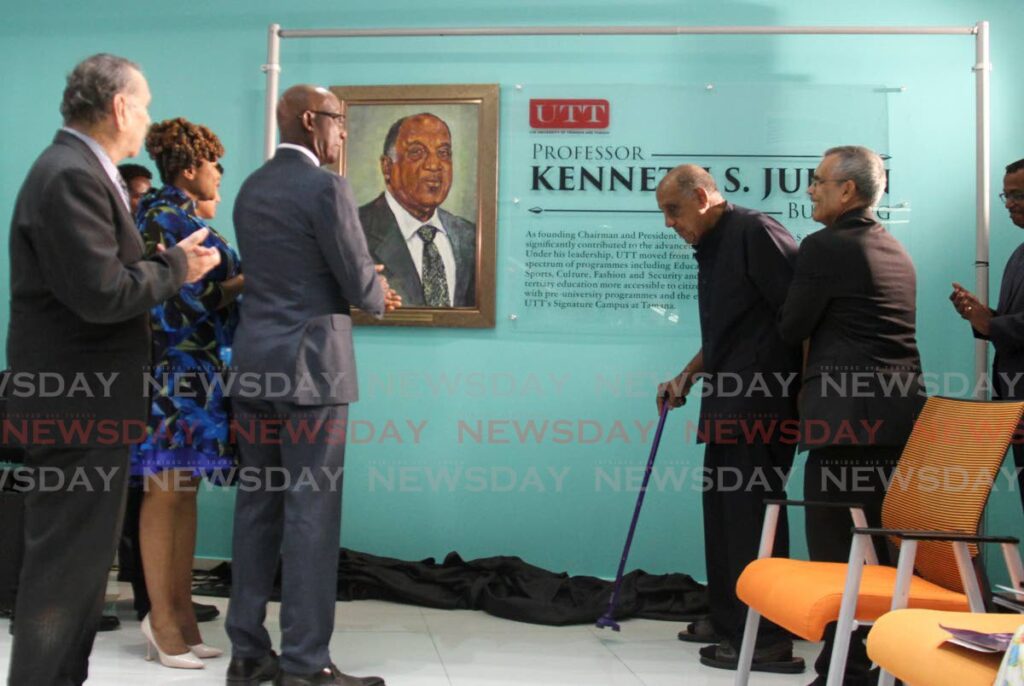 Prime Minister Dr Keith Rowley looks on as Professor Kenneth Julien makes his way to his plaque at the UTT Tamana Campus, Churchill Roosevelt Highway, Wallerfield. The UTT’s administration building was named after Julien on Tuesday.  - Ayanna Kinsale