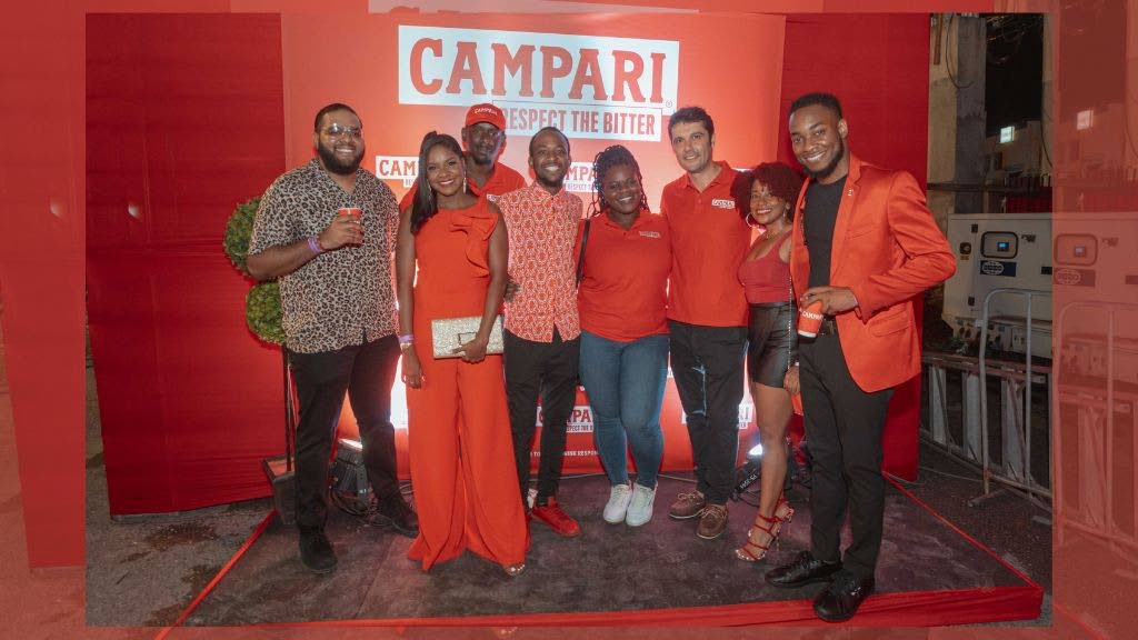 The Campari team at the launch of Campari Respect the Bitter campaign: public relations and communications manager Dominic Bell, Ashley Hinds, event execution analyst Tesfaye Brown, assistant brand manager domestic and export Sheldon Whyte, PR and digital manager Candiese Leveridge; marketing director Pietro Gramegn, public affairs and government relations specialist Samara South, and marketing manager Pavel Smith. - courtesy Kadeem Akeem
