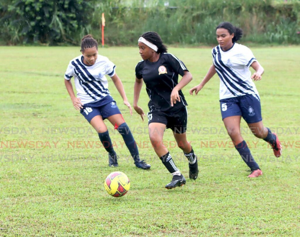 Pleasantville Secondary’s Maya Wong (C) controls the ball against pressure from St Joseph’s Convent Port of Spain players during the Girls Big Five match, on Thursday, at St Joseph’s Convent grounds, Port of Spain.  - ROGER JACOB