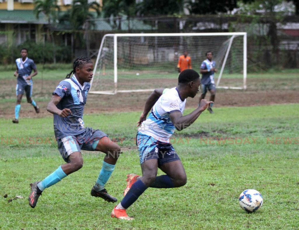 Arima North Secondary's Jemaul Ashing, left, and QRC's Aydon Caruth compete for the ball in an SSFL match on Friday at the QRC ground in St Clair. PHOTO BY AYANNA KINSALE - Ayanna Kinsale