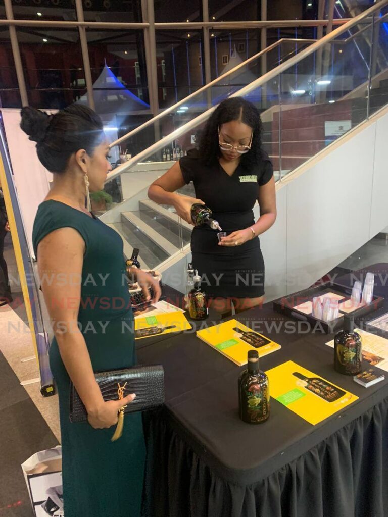 A patron gets ready to sample Tobago Gold Choclate Rum cream at a recent exhibition.  - 