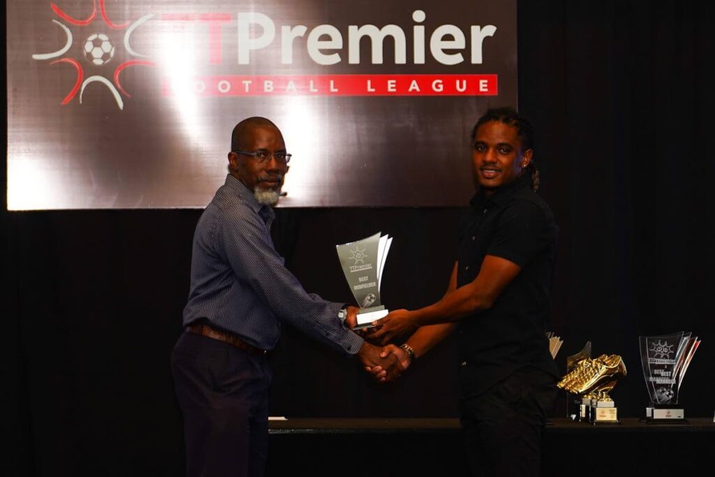 National player and AC Port of Spain midfielder Duane Muckette (R) was named the TT Premier Football League's Midfielder of the Year, during the league's awards ceremony, on Friday, at the Hilton Trinidad, St Ann's. - TT Premier Football League