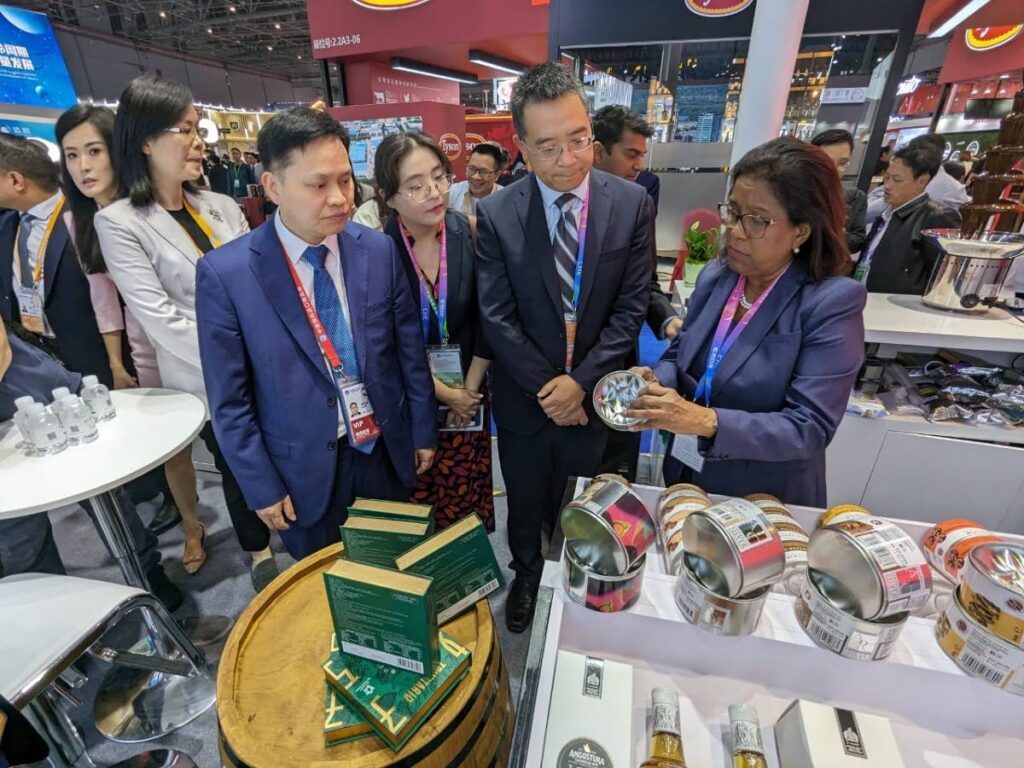 Trade and Industry Minister Paula Gopee-Scoon showcases products from the Trinidad and Tobago Fine Cocoa Company to officials at the 6th China International Import Expo in Shanghai, China. - Joey Bartlett