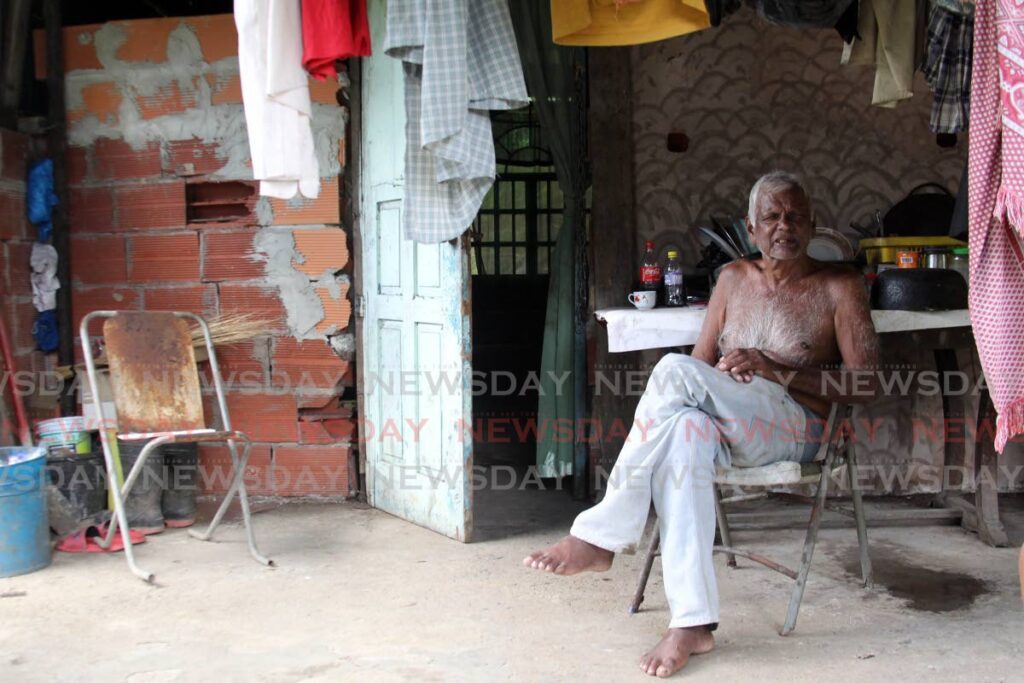 Balgobin Pooran 68, explains to Newsday how he found his neighbour, Gayatree Balchan, dead in his home on Sobo Road Extension Trace, La Brea, on Thursday. - Lincoln Holder