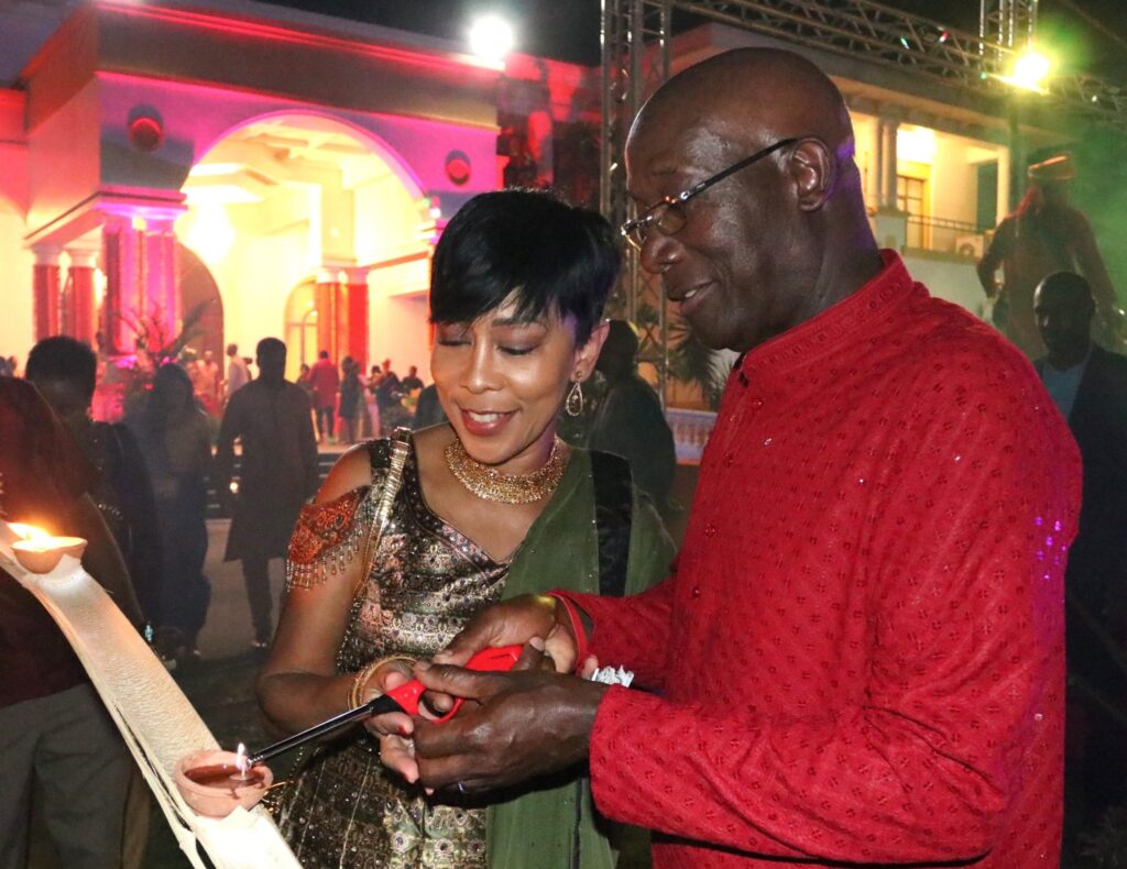 PM Rowley and his wife Sharon Rowley light a deya at Divali celebrations at the Diplomatic centre on Wednesday.  - 