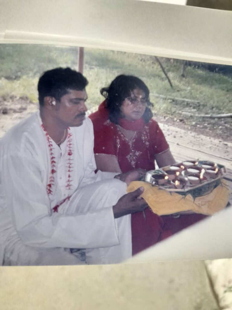 Ann Sookram and her husband Anthony prepare deyas during a Divali celebration some years ago. - 