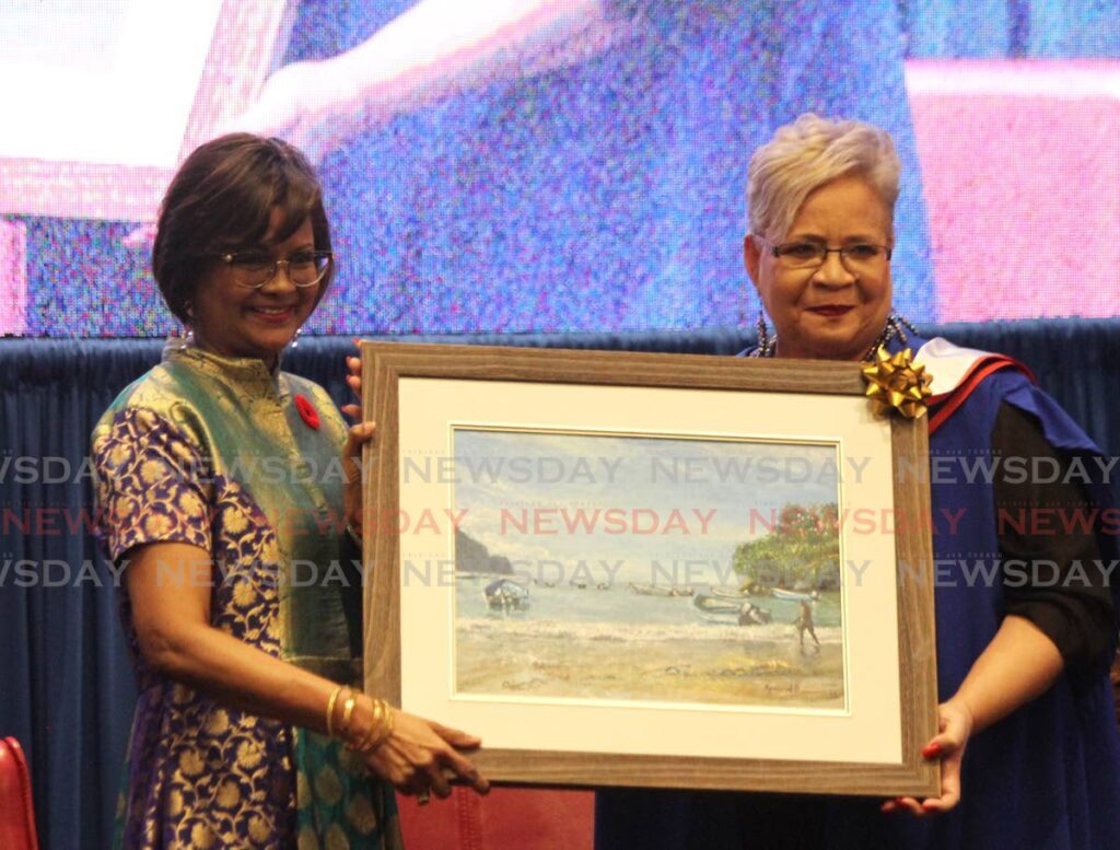 President Christine Kangaloo receives a token from executive director UWI School of Business and Applied Studies Limited (UWI-ROYTEC) Wendy Augustus during the UWI-ROYTEC graduation ceremony at Hilton Trinidad and Conference Centre, Lady Young Road, Port of Spain.  - Ayanna Kinsale