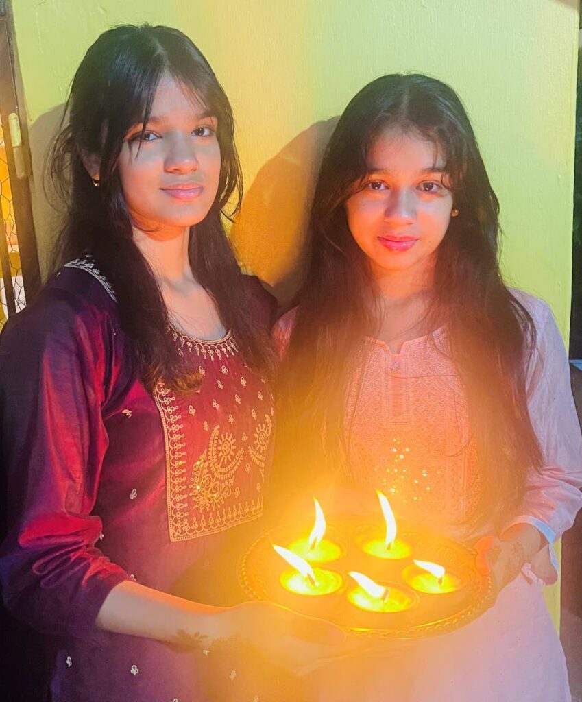 Sisters Anya and Zaara Ibrahim celebrate Divali at their Longdenville home.  -  