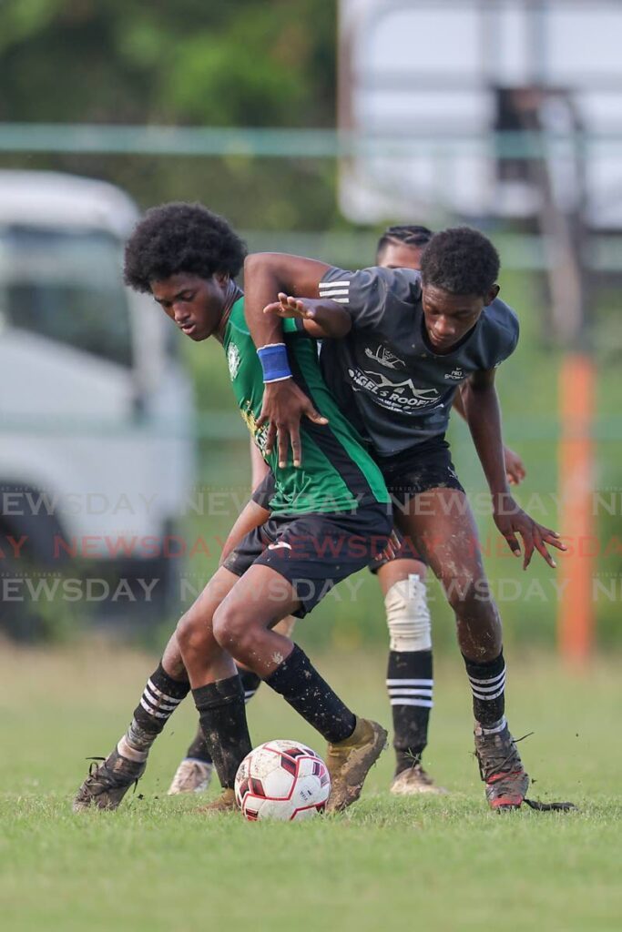 Carapichaima East's Thiam Agard, left, battles Miracle Ministries’ Keon Codrington for the ball during the Coca-Cola Central Zone Intercol semifinal at Edinburgh 500 grounds, Chaguanas on November 14. - Photo by Daniel Prentice
