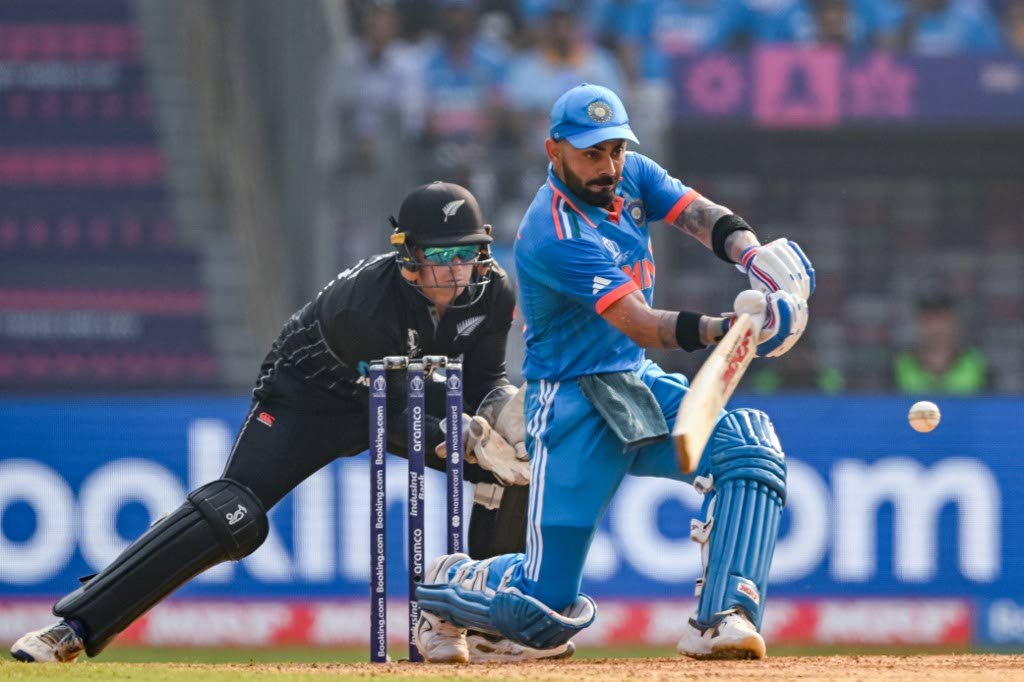India's Virat Kohli (R) plays a shot during the 2023 ICC Men's Cricket World Cup one-day international semi-final against New Zealand at the Wankhede Stadium in Mumbai on Wednesday.  - AFP PHOTO