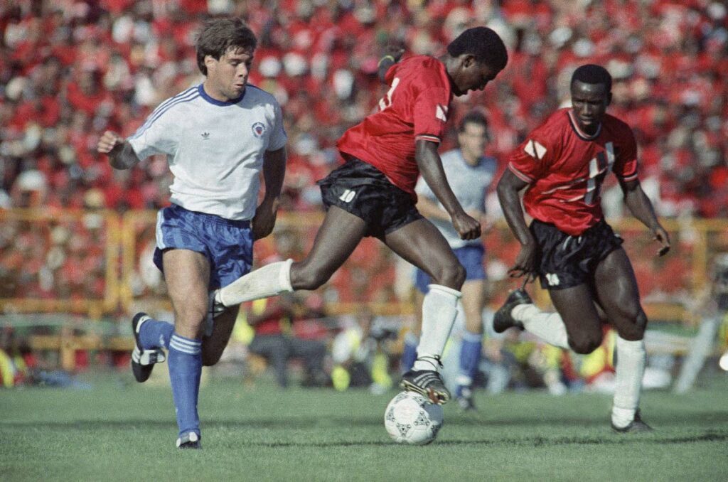TT'S HEARTBREAKER: The USS's Paul Caligiuri, left, engages Strike Squad player Russel Latapy in an Italia 1990 World Cup qualifying match at the Hasely Crawford Stadium in Trinidad on Sunday November 19, 1989. It was Caligiuri's 28-yard shot that secured a 1-0 victory and the US' qualification to the World Cup. AP PHOTO   - Mark Lennihan