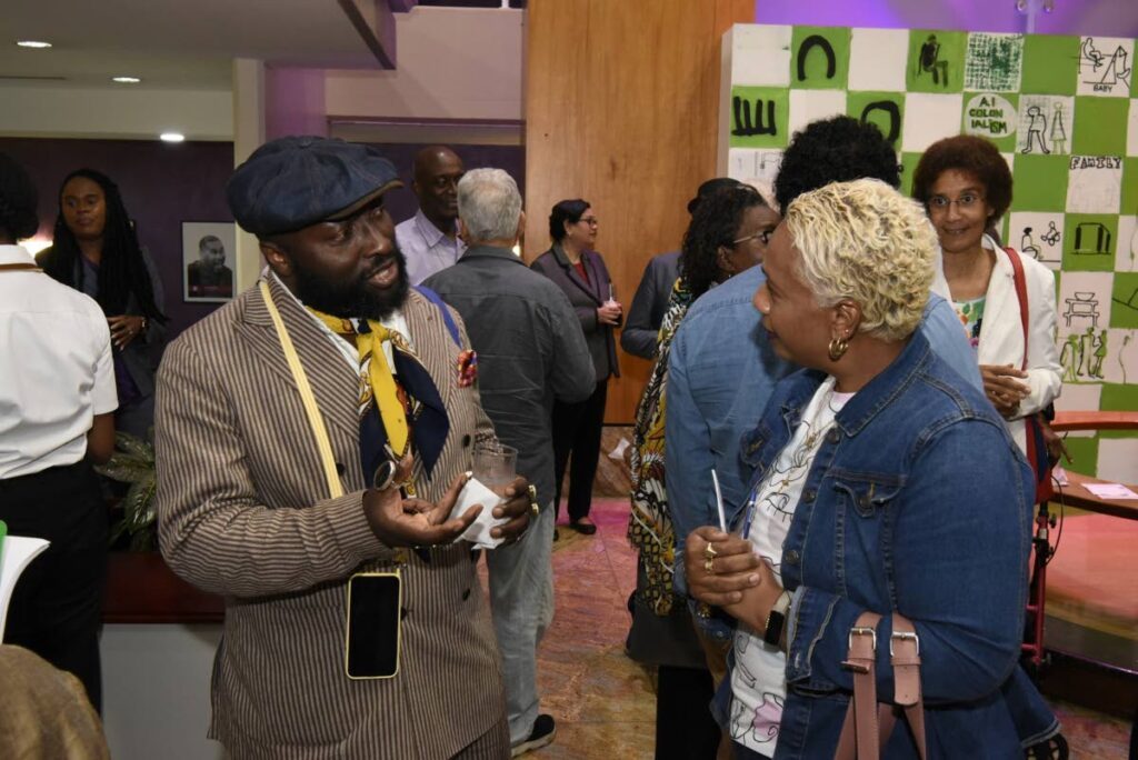 Director and curator of the House of World Cultures in Berlin, Germany Dr Bonaventure Soh Bejeng Ndikung speaks to a guest at the opening of Da Da and Projects 2023 Symposium and exhibition held at Central Bank Auditorium, November 16. Ndikung delivered the symposium's keynote address.  - 