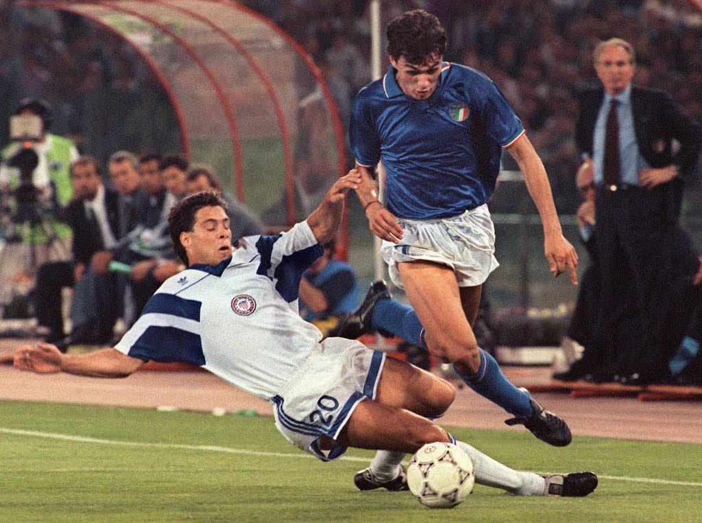 In this June 14, 1990 file photo, Italian defender Paolo Maldini (R) is tackled by US midfielder Paul Caliguri during their 90 World Cup match in Rome. - 