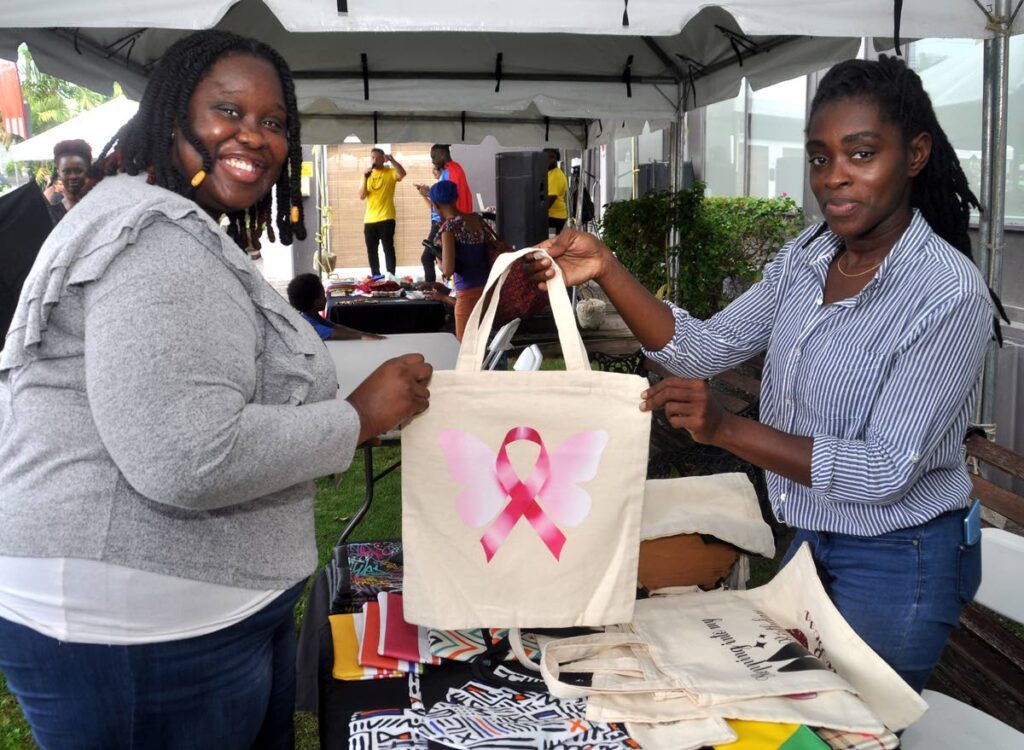 A satisfied customer purchases a handmade tote bag from the owner of Off The Hook DZigns, Sharlene Bramble (right) at the Ross | ReThink World Kindness Day celebrations. - 