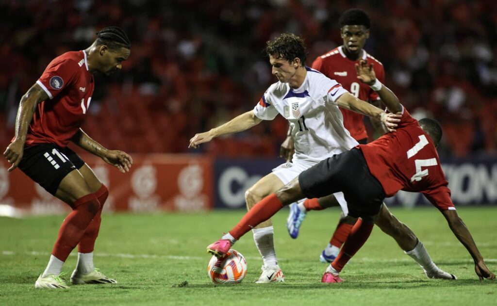United States’ Brenden Aaronson (C) fights for the ball with TT’s Shannon Gomez (R) and Alvin Jones (L) during a Concacaf Nations League quarterfinal match, at the Hasely Crawford Stadium, Port of Spain, on Monday - AP PHOTO