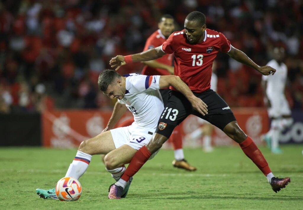 United States' Ricardo Pepi (L) fights for the ball with TT's Reon More, during a CONCACAF Nations League quarterfinal match at Hasely Crawford Stadium, Port of Spain, on November 20.  - AP PHOTO