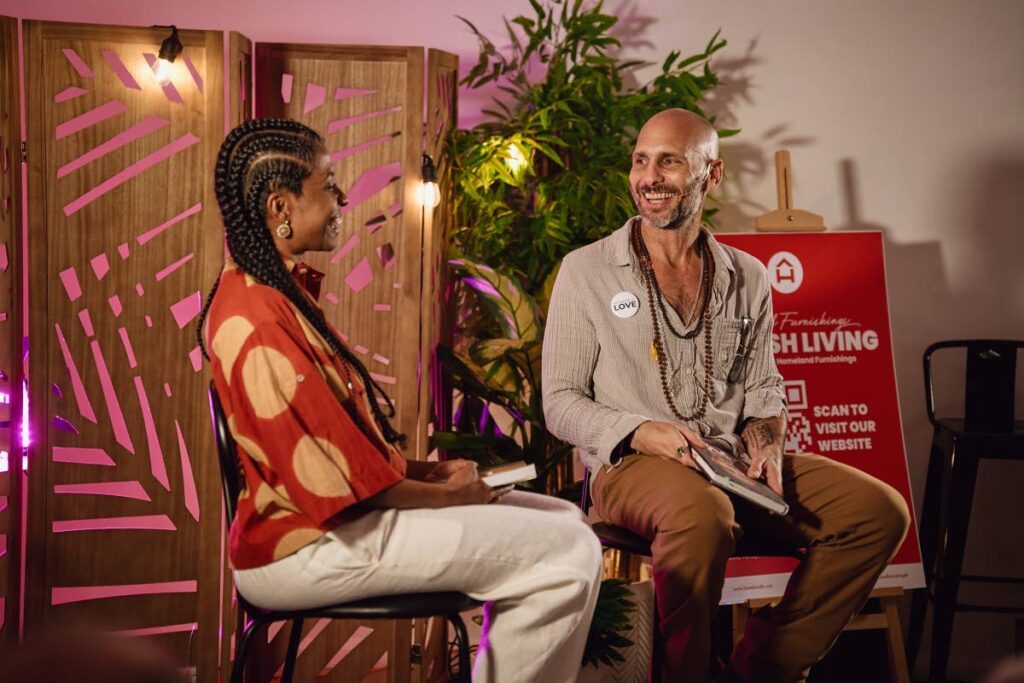 Troy Hadeed shares a lighthearted moment with host Ardene Sirjoo at the launch of his debut book My Name Is Love on November 4 at the Beyond Yoga studio on Wrightson Road - Courtesy Jason C Audain