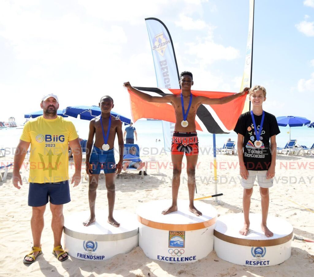 Trinidad and Tobago's Che'don Grant, third from left, celebrates his boys 12 and under gold medal at the Biig International Barbados Beach Wrestling Open  over the weekend.  - 