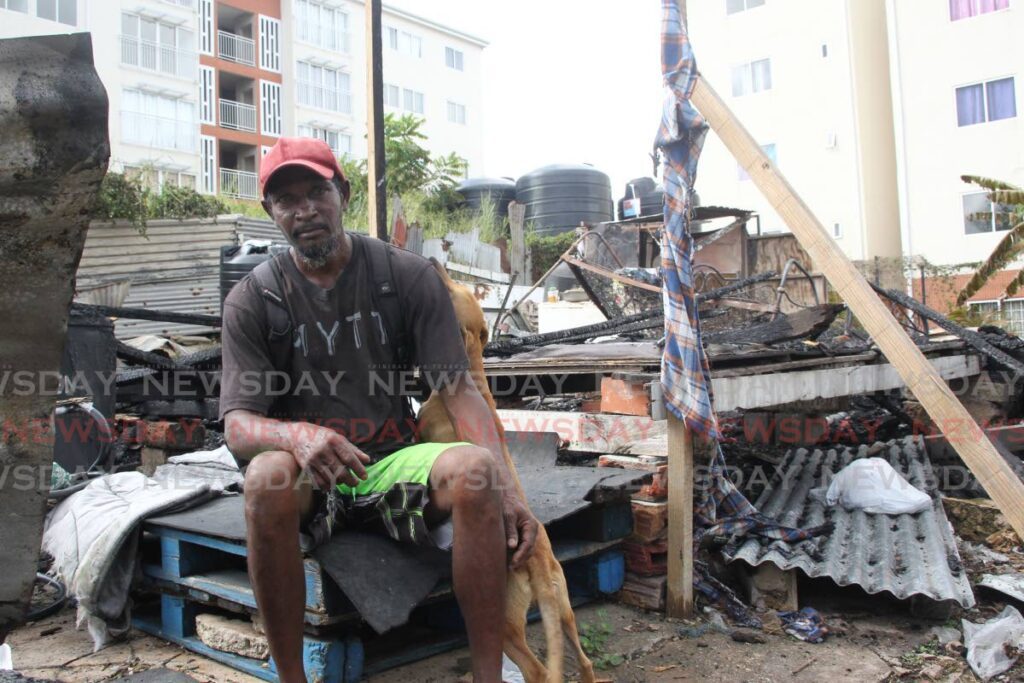 Kevin Poorai of Gooding Street San Fernando sits outside the burnt structure he called home after it was gutted by fire on Wednesday night  - Lincoln Holder