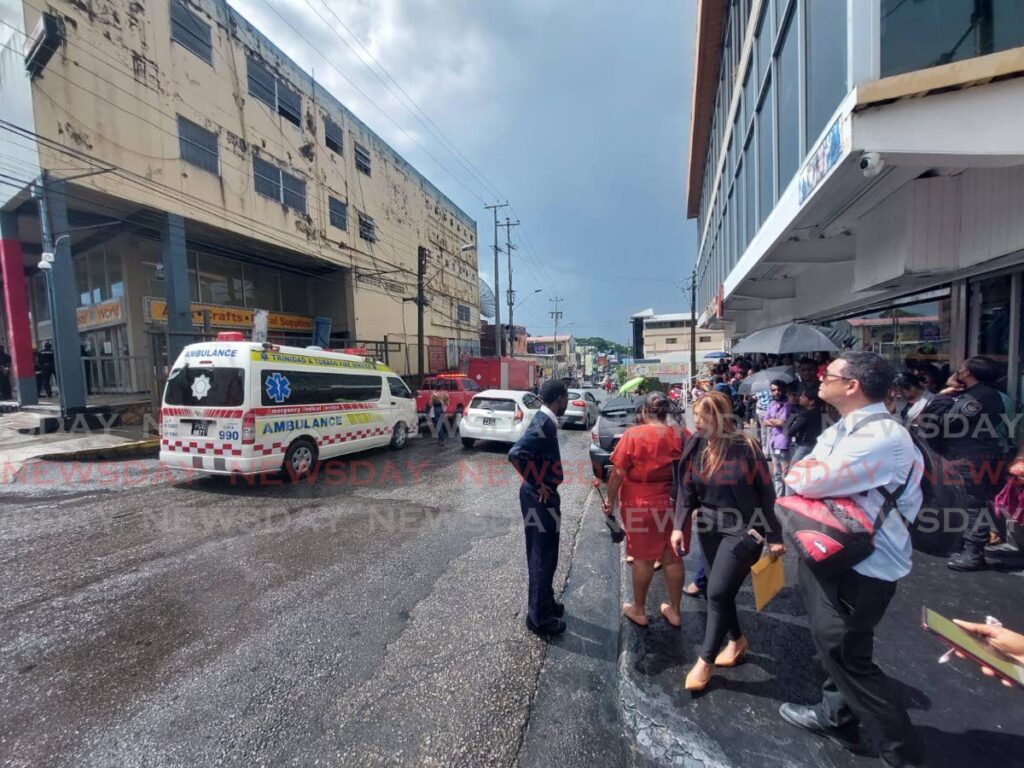 Staff from several businesses in Carlton Centre, San Fernando were evacuated after a bomb threat shortly before noon on Friday.  - Photo by Lincoln Holder 