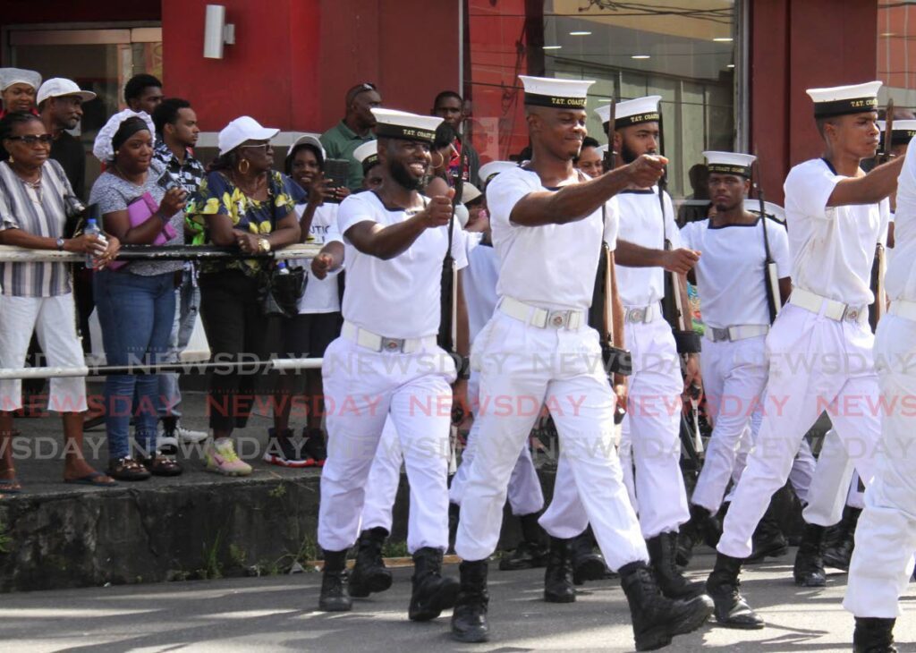 Spectators observe members of the Coast Guard during the San Fernando City Corporation military parade on High Street, San Fernando on Saturday commemorating the southern city's 35th anniversary. - AYANNA KINSALE