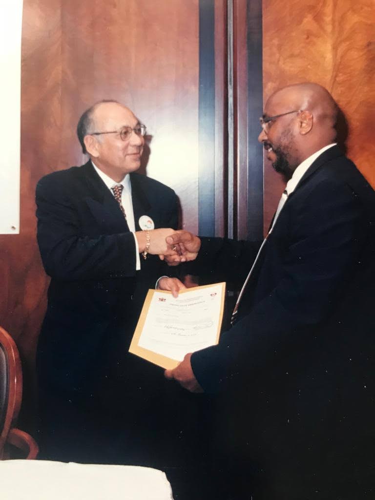 Francis Regis presenting the certificate of airworthiness for the first boeing 737-800 aircraft to BWIA CEO Conrad Aleong in 2000 at the Boeing factory in Seattle, USA. - 