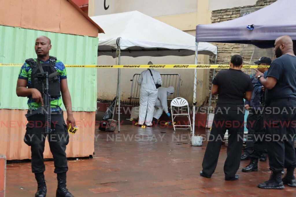 Crime scene investigators process the murder of Jeffrey Joseph near Building C of Charford Courts on Upper Charlotte Street in Port of Spain on Wednesday November 29, 2023. - Photo by Roger Jacob