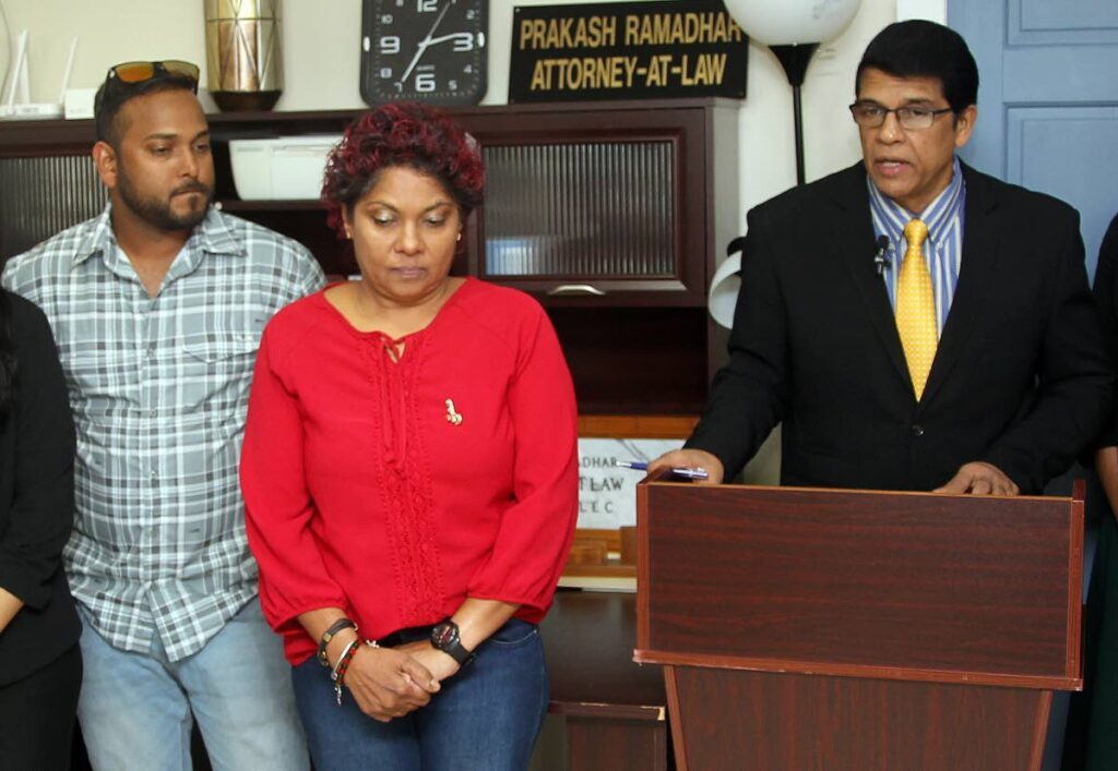 Michael and Celisha Kurban, wife and son of Fyzal Kurban one of the deceased divers in the Paria tragedy and attorney Prakash Ramadhar during a press conference held at Lord street San Fernando. - 