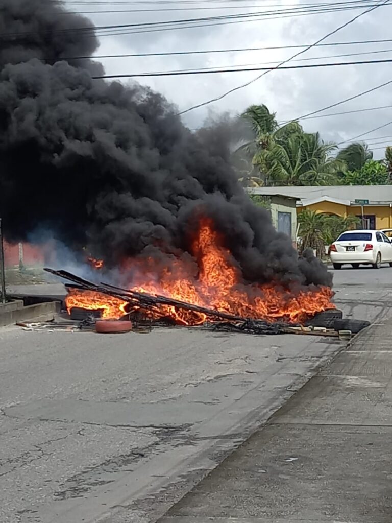 Residents of Northeastern Settlement, Sangre Grande block the road in protest on Tuesday morning November 28, 2023 after an alleged fatal police shooting around 5am.