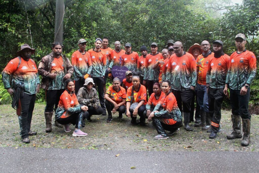 Captain of the Hunters' Search and Rescue Team Vallence Rambharat (back row, third from left) with his members and several volunteers.  - Photo by Roger Jacob