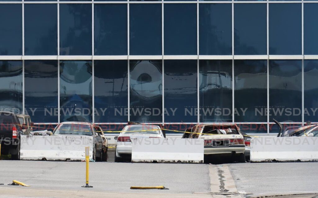 Several cars parked in the impound space of the head office at the MOWT Licensing Authority Office in Caroni had to be extinguish after an unknown fire earlier on the morning of Sunday November 26 2023. - Photo by Roger Jacob