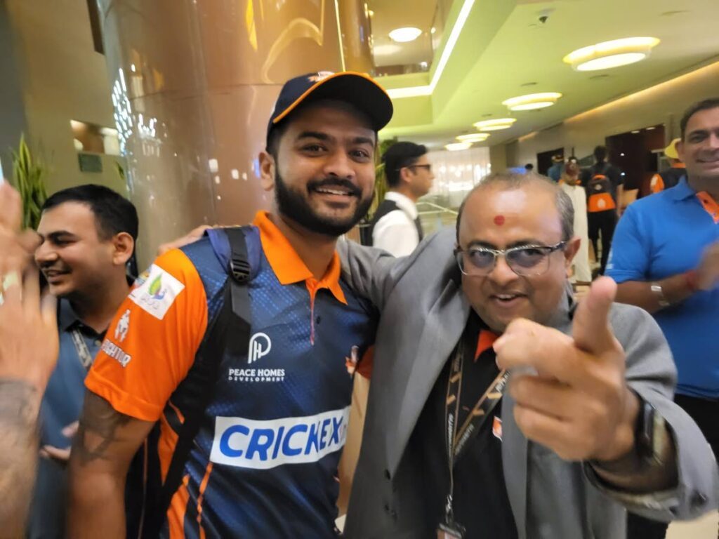 US wicketkeeper Monank Patel, left, is embraced by Samp Group chairman Ritesh Patel in Abu Dhabi.  - 