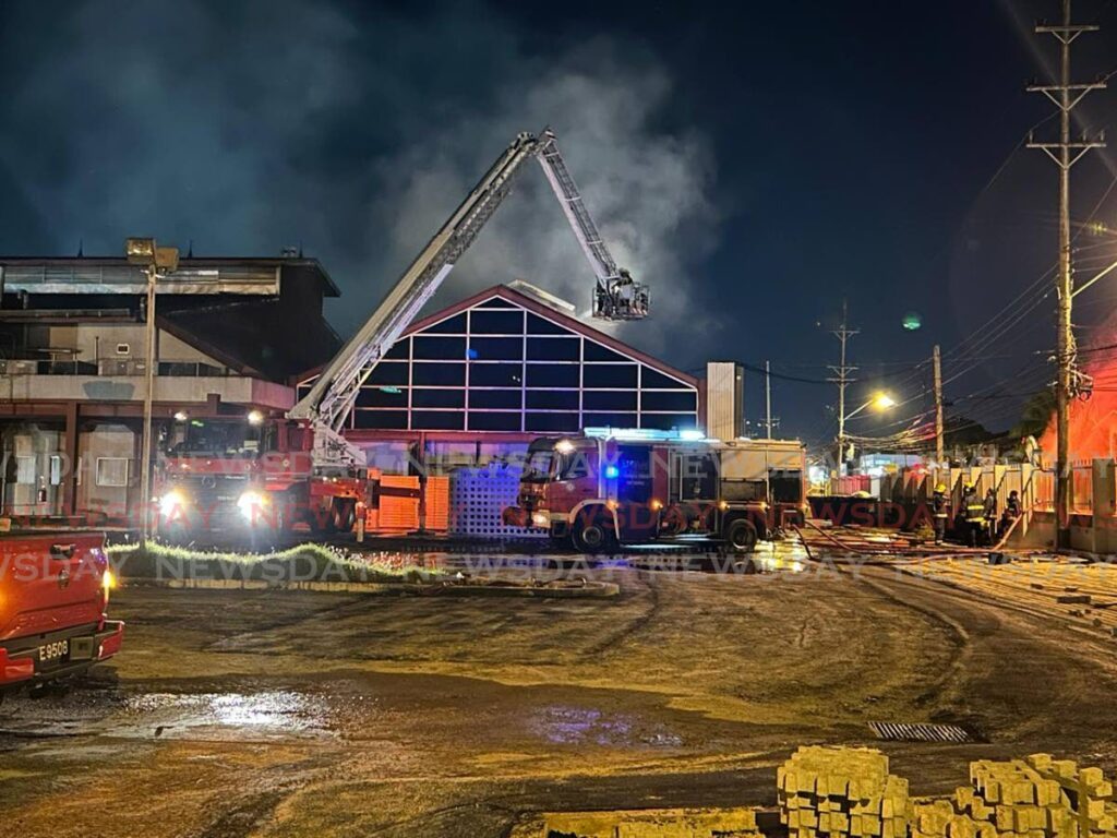 Fire services on the Angostura compound, along the Eastern Main Road, after a fire broke out the compound on Friday evening.  - Rishard Khan 