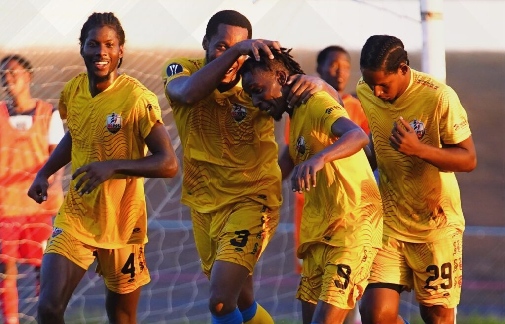 AC Port of Spain's Kadeem Corbin (9) is congratulated by teammates after scoring against 1976 Phoenix FC during the TT Premier Football League match, on Friday, at the Dwight Yorke Stadium, Bacolet. - Photo courtesy TT Premier Football League