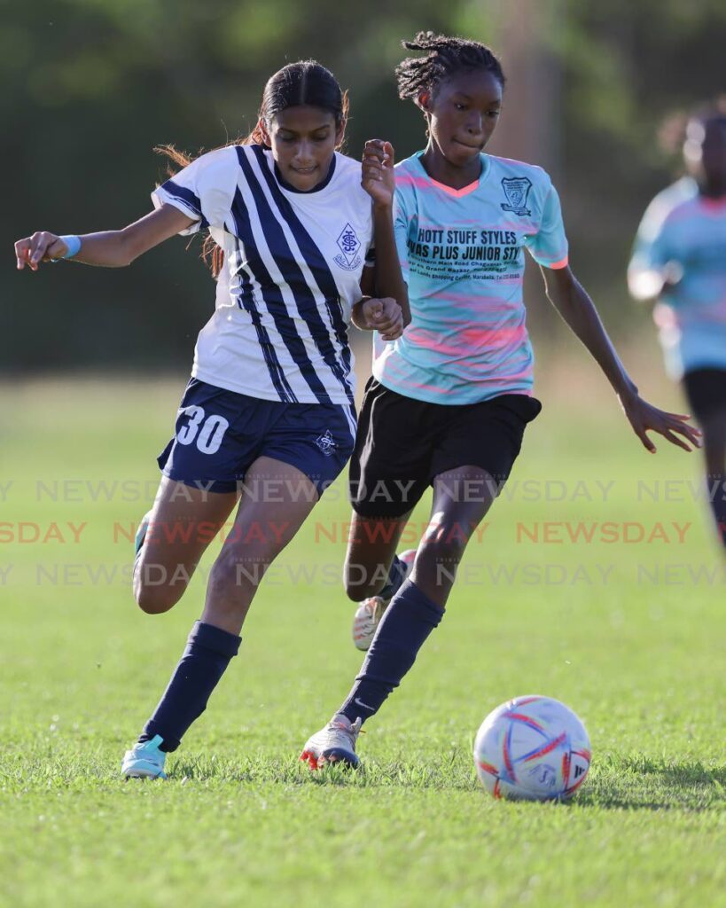 St Joseph's Convent's Bethany Phillip, left, vies for possession of the ball with Miracle Ministries' Amiya Cumberbatch during the Coca Cola Girls National Intercol semifinal at the Couva East Secondary School Ground on Sunday.  - DANIEL PRENTICE