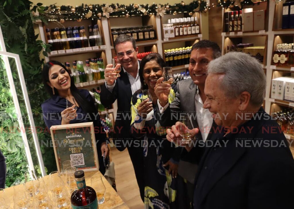 Acting PM and Finance Minister Colm Imbert, right, toasts to the new Solera Store, alongside Angostura chairman Terrence Bharath SC, Trade Minister Paula Gopee-Scoon, Angostura CEO Laurent Schun and Minister in the AGLA Ministry Renuka Sagramsingh on Monday.  - ROGER JACOB
