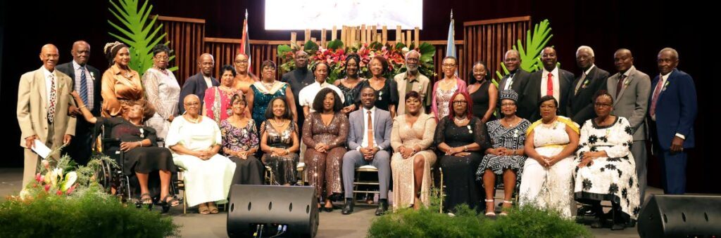 THA Chief Secretary  Farley Augustine, centre, his wife Takyana Augustine, fifth from left, and THA chief administrator Denese Toby-Quashie, fifth from right, take a photo among Tobago Day awardees. Photo courtesy THA - Photo courtesy THA  