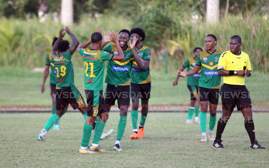 St Benedict’s College playeres celebrate a goal against Fatima College, on Tuesday, during the Secondary Schools Football League Under-20 final, at the Manny Ramjohn Stadium training field, Marabella. St Benedict’s won 2-1. - 