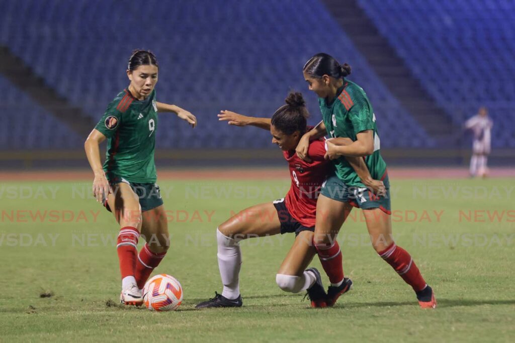 TT Zoe Maxwell, centre, battle for possession against Mexico’s Kiana Palacios, left, and Nicole Perez during the Concacaf Women's Gold Cup qualifier at the Hasely Crawford Stadium, Mucurapo on Tuesday. - Photo by Daniel Prentice