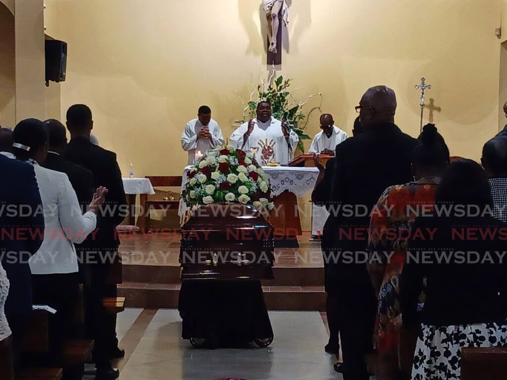 Mourners gather to pay their respects to the late Toco councillor Martin 