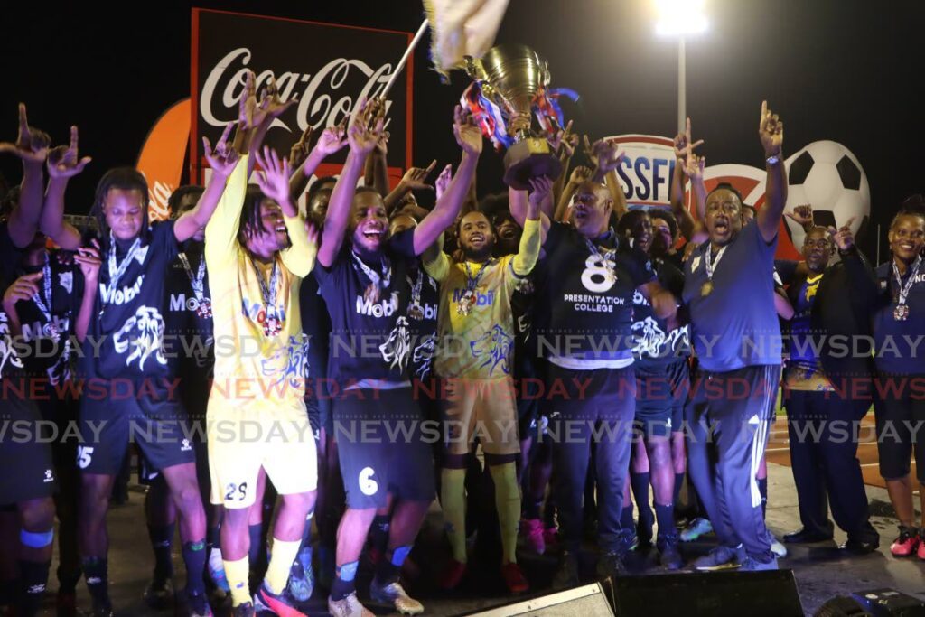 Presentation College celebrate winning the SSFL Boys Championship Division against St Anthony's College, at the Hasley Crawford Stadium, Port of Spain on Thursday.  Goalkeeper, captain and MVP Kanye Lazarus holds the trophy.  - Angelo Marcelle